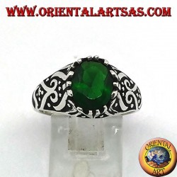 Silver ring with oval emerald zircon and high relief decorations on the sides