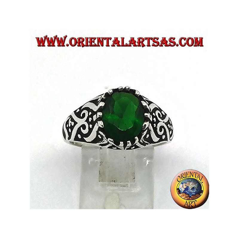 Silver ring with oval emerald zircon and high relief decorations on the sides