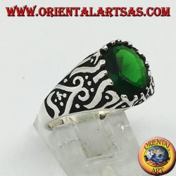 Silver ring with oval emerald zircon and high relief decorations on the sides