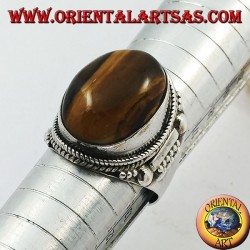 Silver ring with oval cabochon tiger's eye and Indian decorations