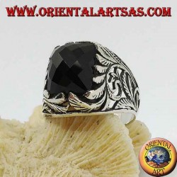 Silver ring with faceted rectangular onyx and openwork floral decorations