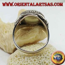 Silver ring with large blue eye and flower on the sides