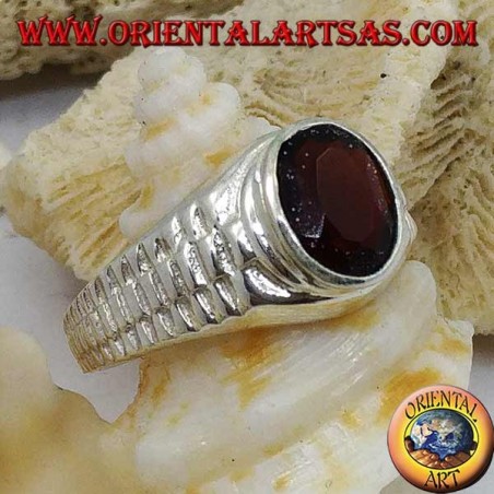 Silver ring with oval garnet and clock link decoration