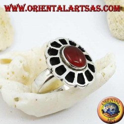 Silver ring in the shape of a flower with an oval carnelian and openwork petals