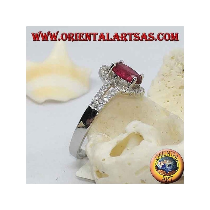 Silver ring with synthetic oval ruby set surrounded by a row of double cubic zirconia