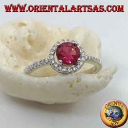 Silver ring with synthetic round ruby set surrounded by a row of zircons