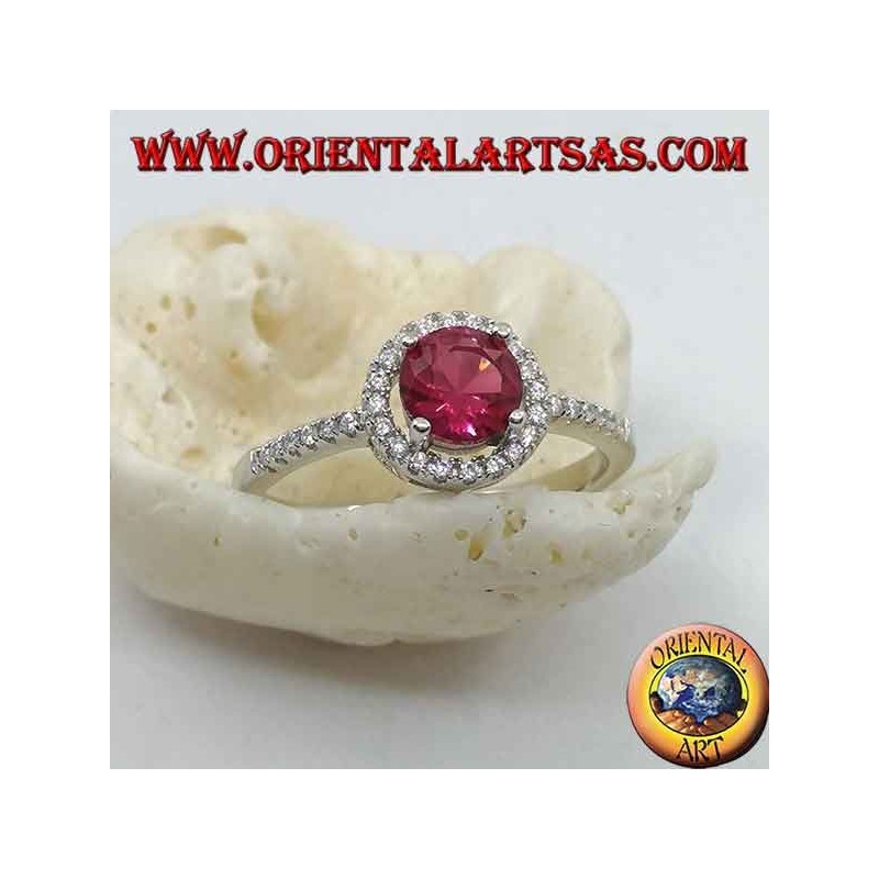 Silver ring with synthetic round ruby set surrounded by a row of zircons