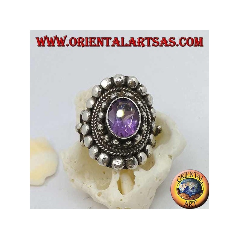 Silver ring with natural oval amethyst on a Nepalese style frame with disks and plaits