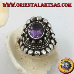 Silver ring with natural oval amethyst on a Nepalese style frame with disks and plaits
