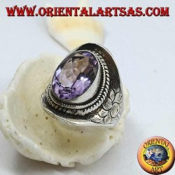 Silver ring with natural oval amethyst surrounded by intertwining and floral design on the sides
