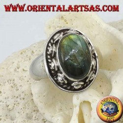 Silver ring with oval labradorite surrounded by studs and braid