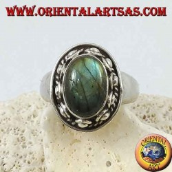 Silver ring with oval labradorite surrounded by studs and braid