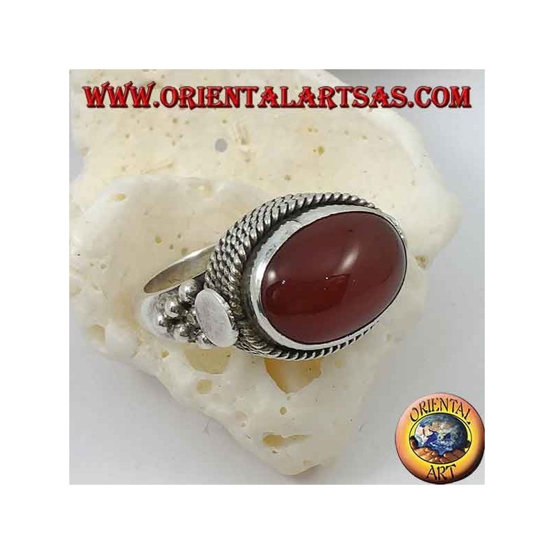 Silver ring with natural oval carnelian sideways surrounded by four rows of dots