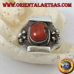Silver ring with antique Tibetan oval coral and Nepalese setting with flower on the sides