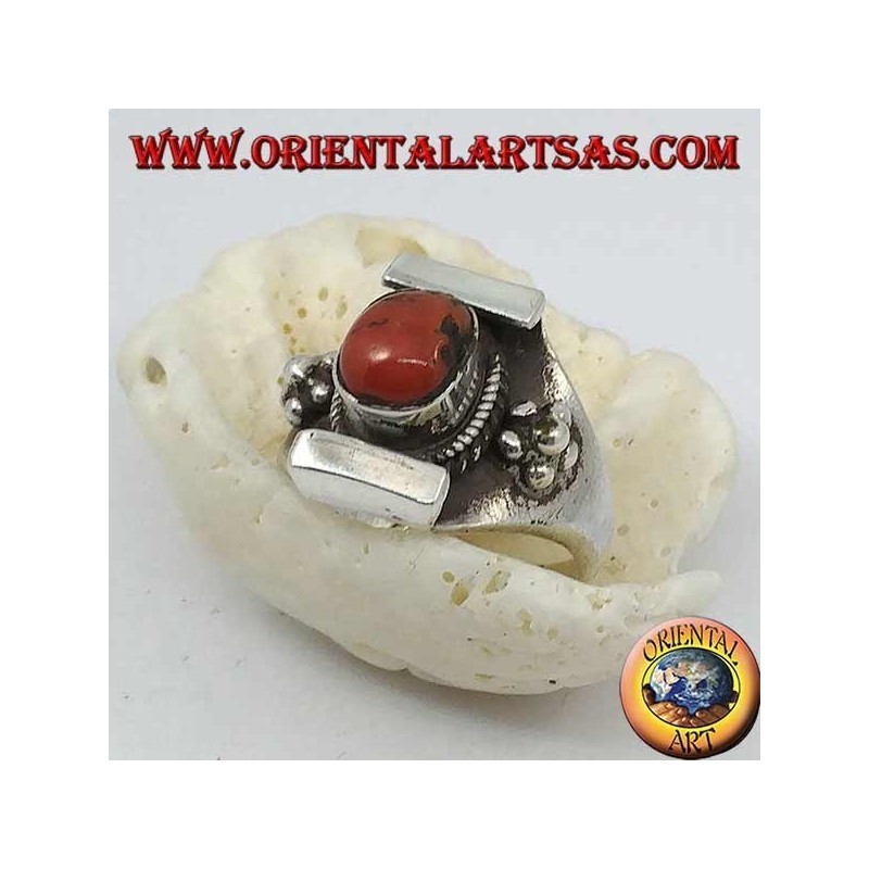 Silver ring with antique Tibetan oval coral and Nepalese setting with flower on the sides