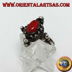 Silver ring with natural oval coral on a Tibetan setting with balls on the cardinal points