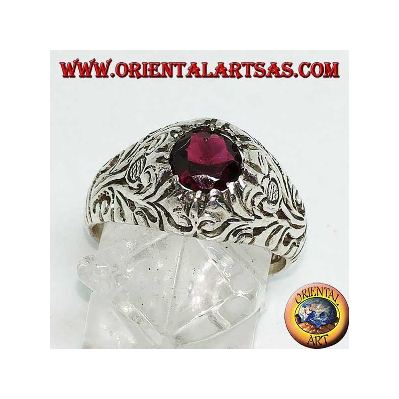 Silver ring with round natural garnet on a frame with openwork floral decoration