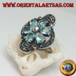 Silver Bethlehem flower ring with blue topaz petals set crowned with silver and marcasite