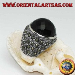 Silver ring with round faceted cabochon onyx surrounded by marcasites on the sides