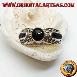 Silver band ring with round onyx between two ovals surrounded by