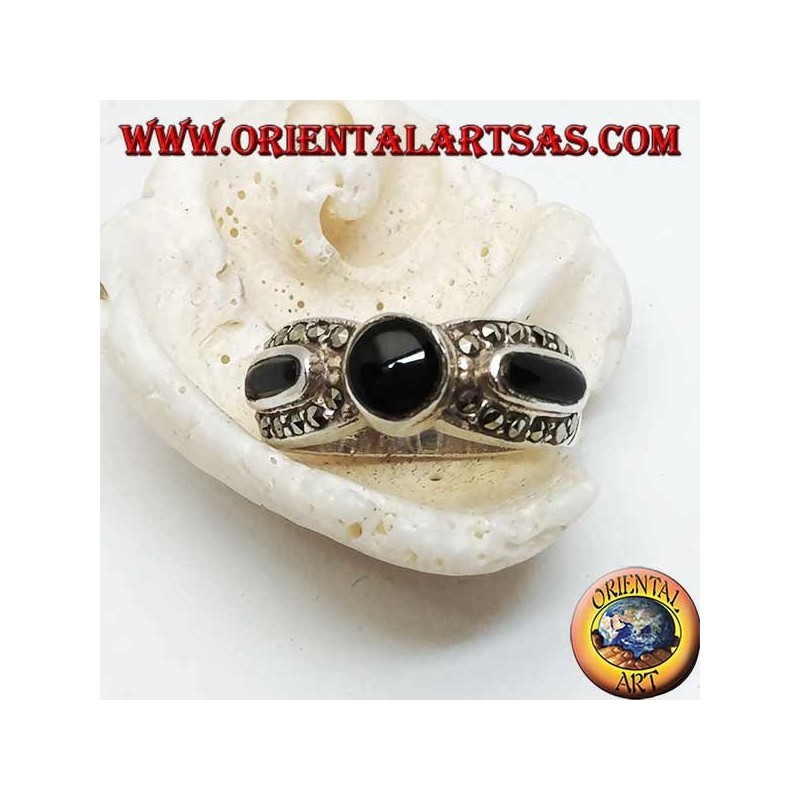 Silver band ring with round onyx between two ovals surrounded by