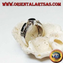 Silver band ring with round onyx between two ovals surrounded by