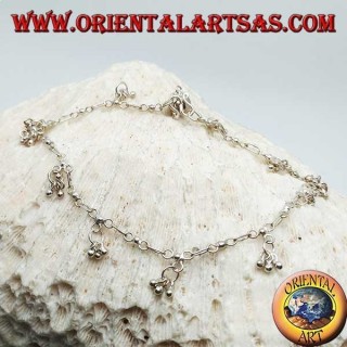 Bracelet de cheville en argent avec une série de trois boules suspendues avec une cloche
