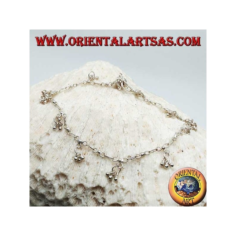 Cavigliera in argento con serie di tre palline pendenti con un campanellino