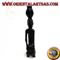Sculpture of a water pumping woman (water carrier) kneeling in ebony wood