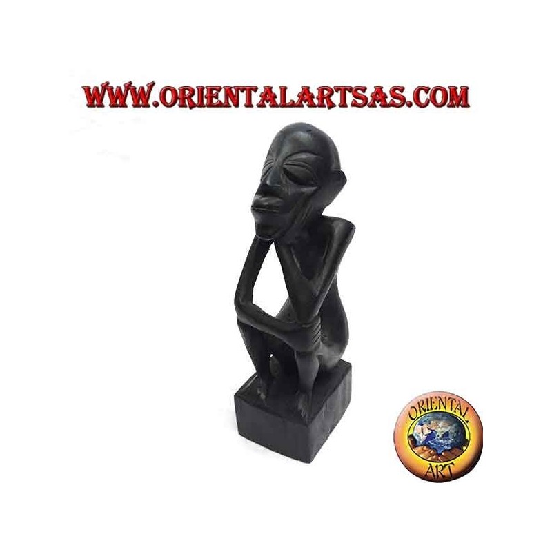 Sculpture of a seated thinker with bent legs in ebony wood
