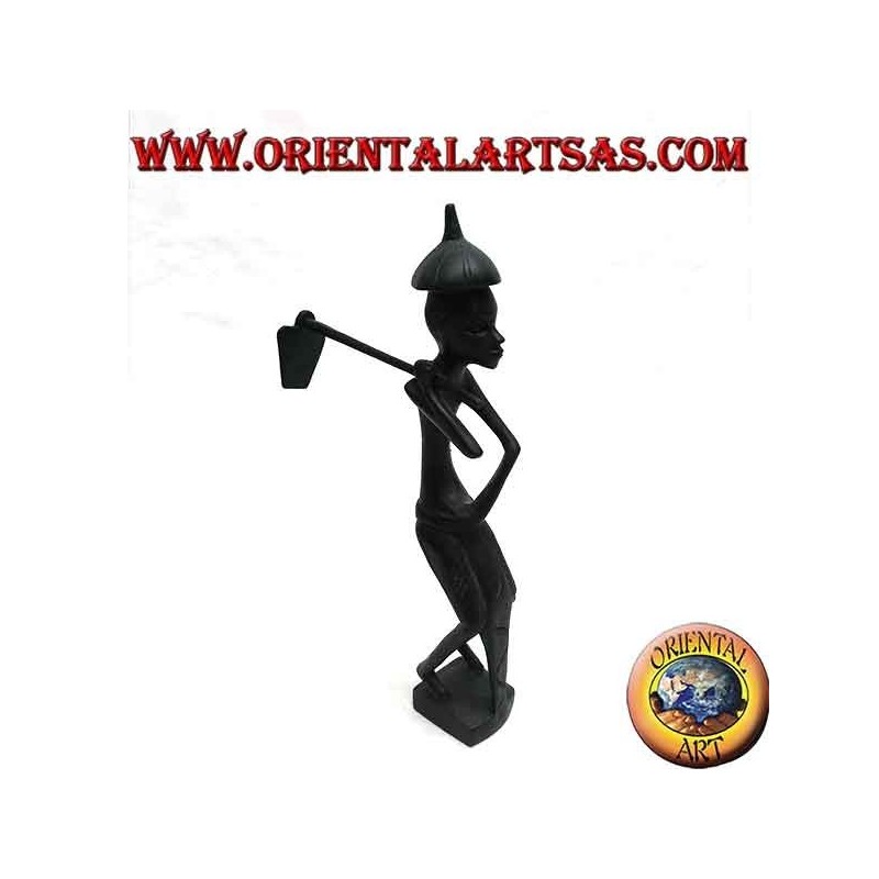 Sculpture of a farmer holding a hoe on the shoulder and a pointed ebony hat