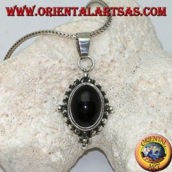 Silver pendant with oval onyx cabochon surrounded by subtle weave, dots and the four cardinal points