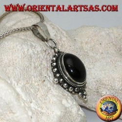 Silver pendant with oval onyx cabochon surrounded by subtle weave, dots and the four cardinal points