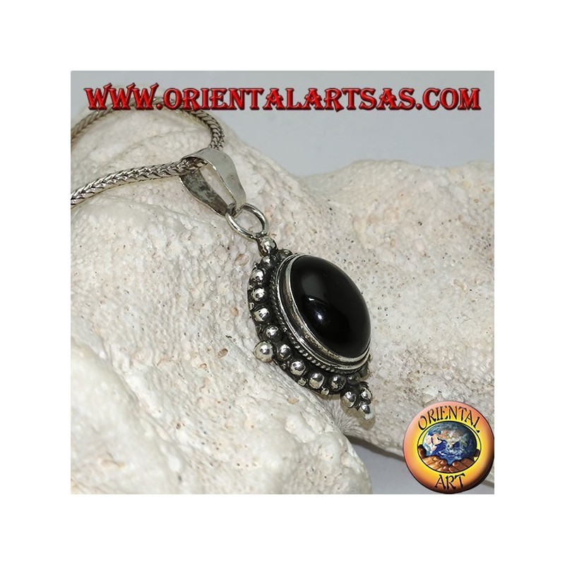 Silver pendant with oval onyx cabochon surrounded by subtle weave, dots and the four cardinal points