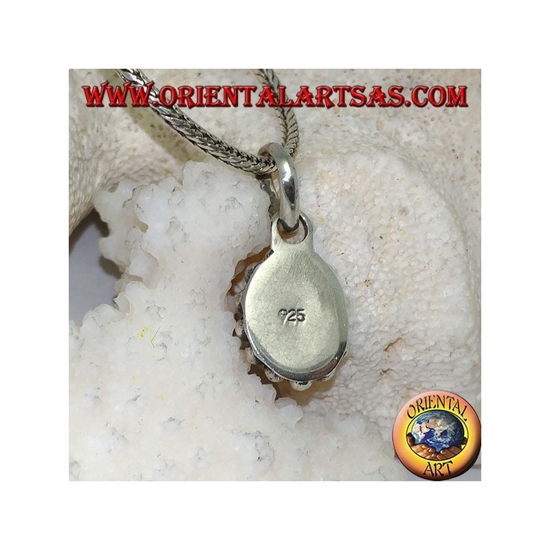 Silver pendant with oval and faceted natural blue topaz surrounded by rows of small and large balls