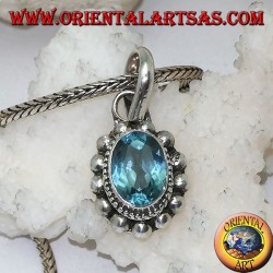 Silver pendant with oval and faceted natural blue topaz surrounded by rows of small and large balls