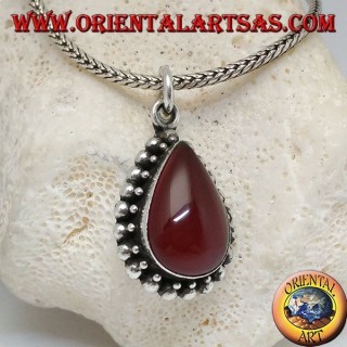 Silver pendant with teardrop cabochon carnelian surrounded by a row of small and large balls