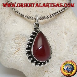 Silver pendant with teardrop cabochon carnelian surrounded by a row of small and large balls