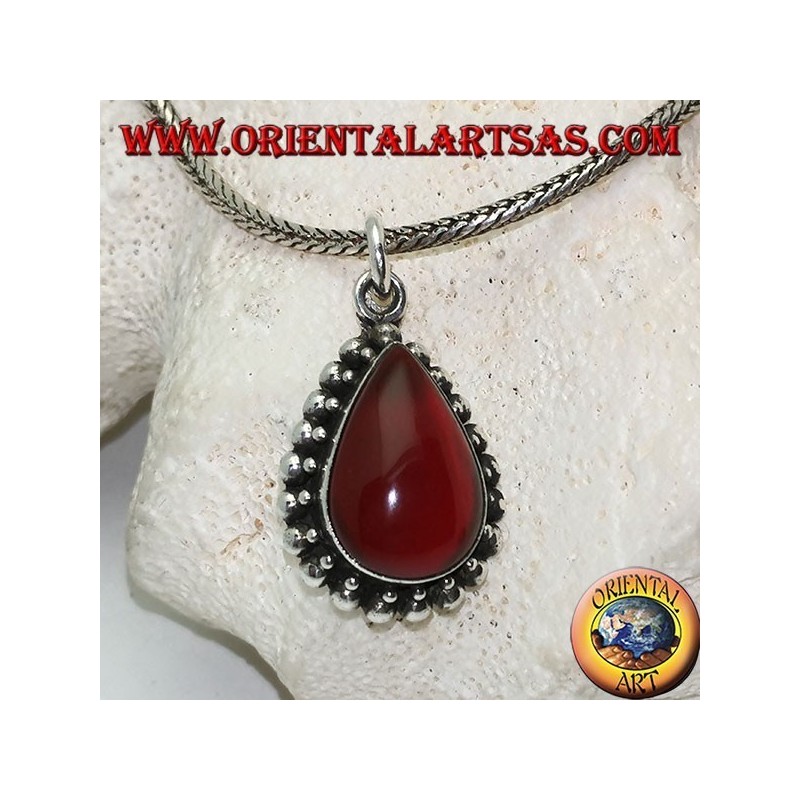 Silver pendant with teardrop cabochon carnelian surrounded by a row of small and large balls