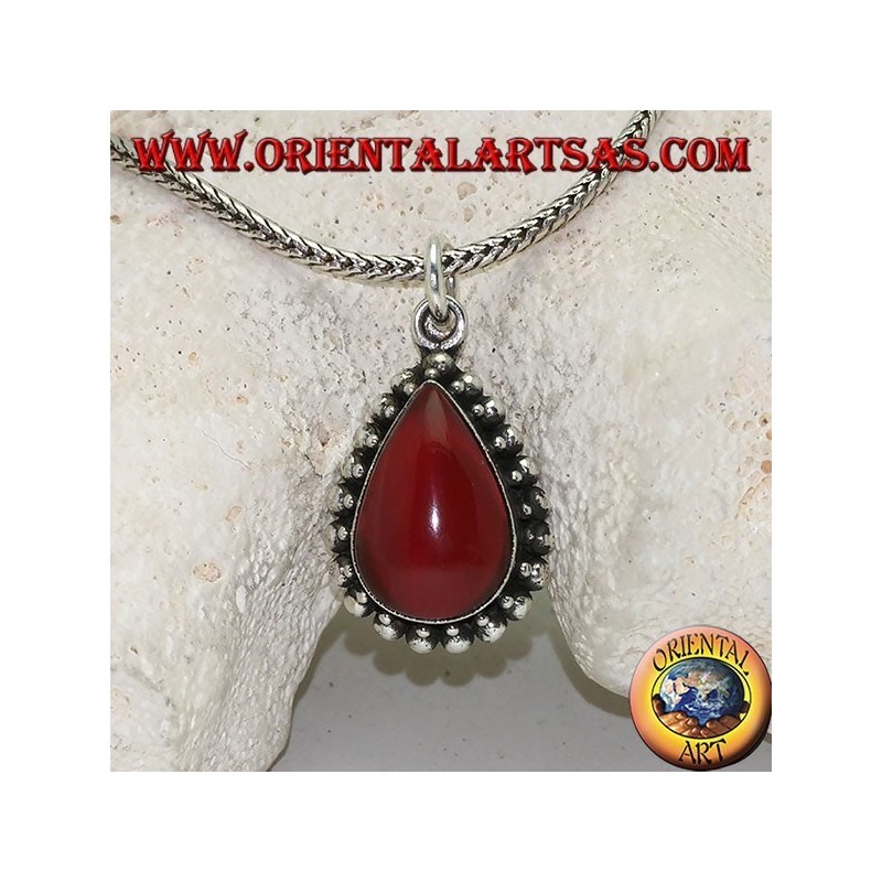 Silver pendant with teardrop cabochon carnelian surrounded by a row of small and large balls