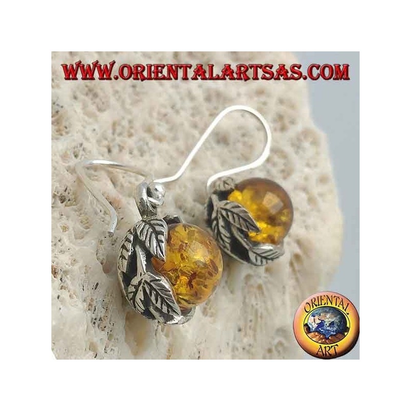 Boucles d'oreilles en argent avec sphère d'ambre naturelle entre les feuilles