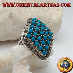 Rhomboid silver ring studded with turquoise balls set surrounded by a row of marcasite stones