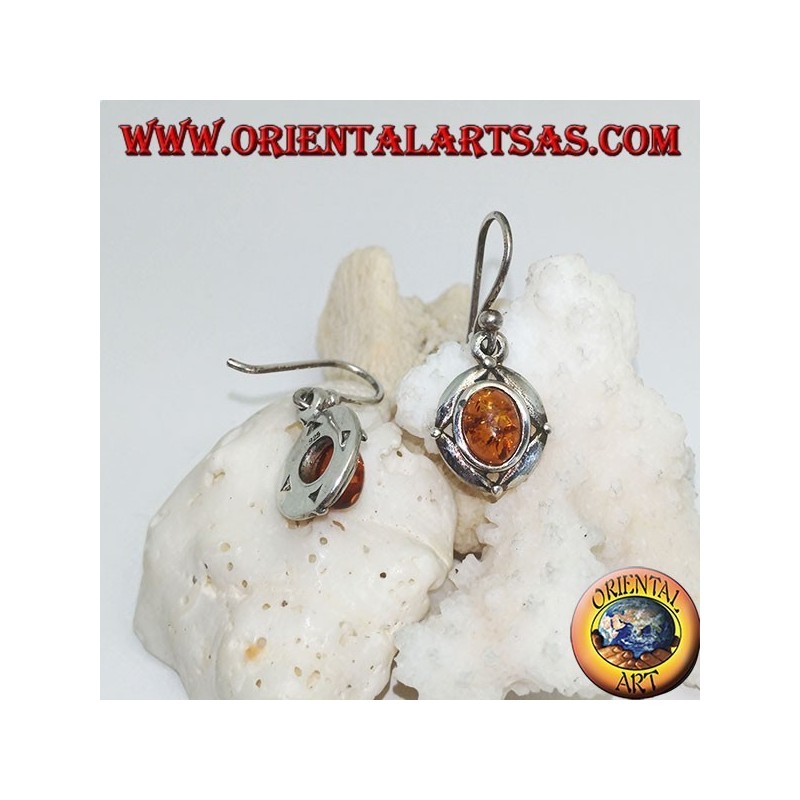 Silver earrings with oval natural amber surrounded by a disc with a ball on the cardinal points