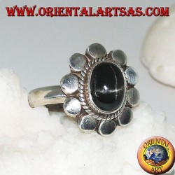 Silver flower ring with oval cabochon black star surrounded by plaiting and diskettes