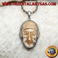 Silver pendant with a face cameo on a fang