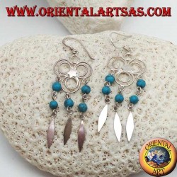 Pendientes de plata de tres círculos con estrella central y hileras colgantes de bolas de turquesa y plata.