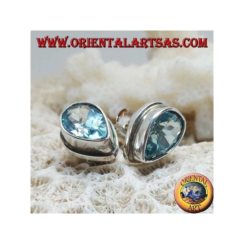 Silver lobe earrings with blue drop topaz on a simple silver setting