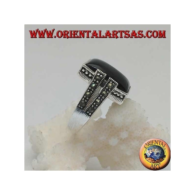 Silver ring with rectangular onyx in a dotted frame with two staples with marcasite on the sides