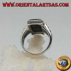 Silver ring with rectangular onyx in a dotted frame with two staples with marcasite on the sides
