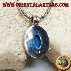 Silver pendant with oval turquoise cabochon on a thick smooth frame and a striped hook